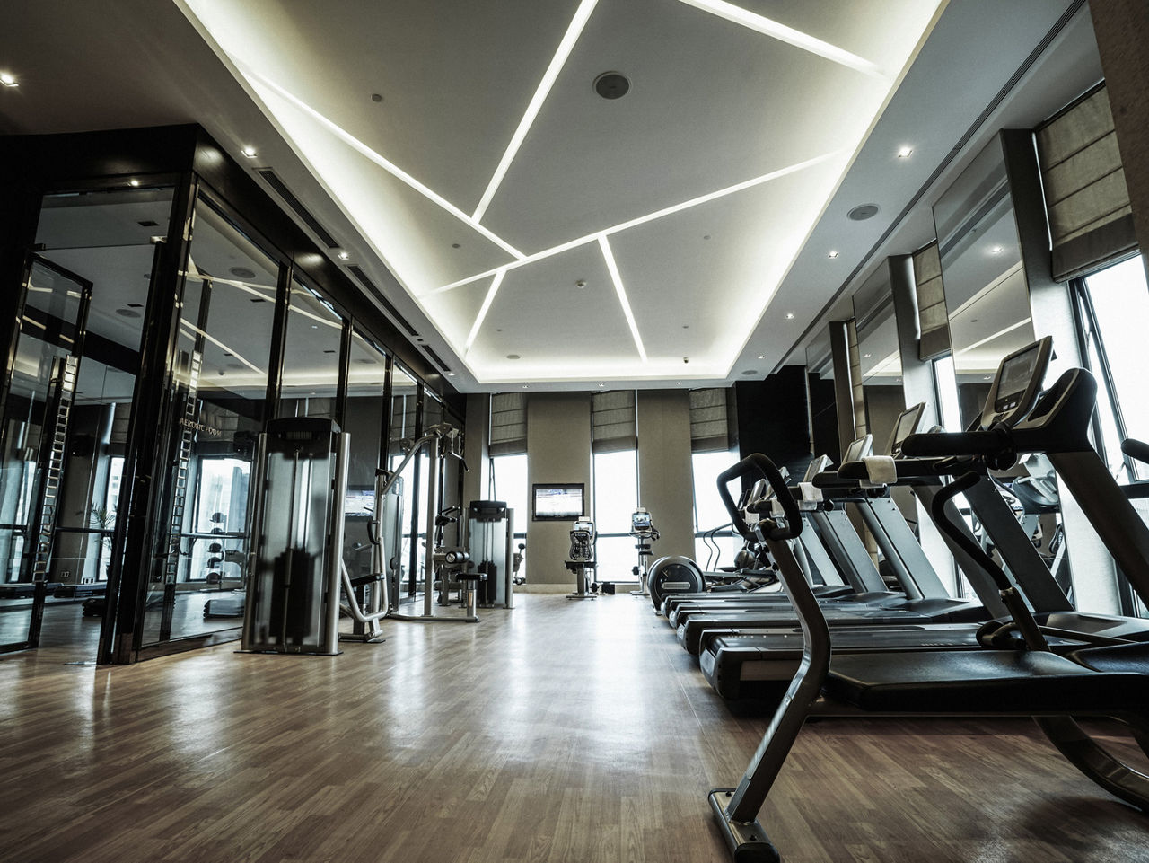 Indoor fitness center with cardio equipment and wood flooring | Blog | Greystar 
